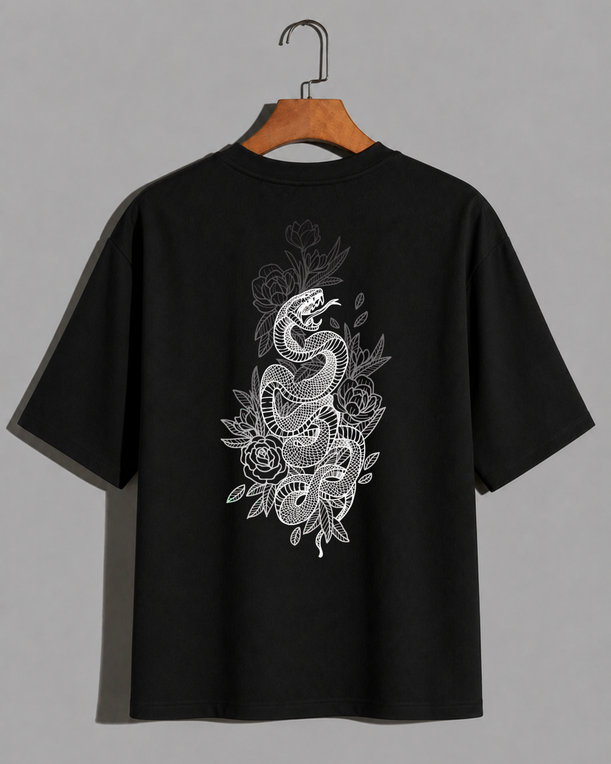 "Black oversized t-shirt with detailed white snake coiled among flowers graphic on the back, VenomX dangerous elegance streetwear design